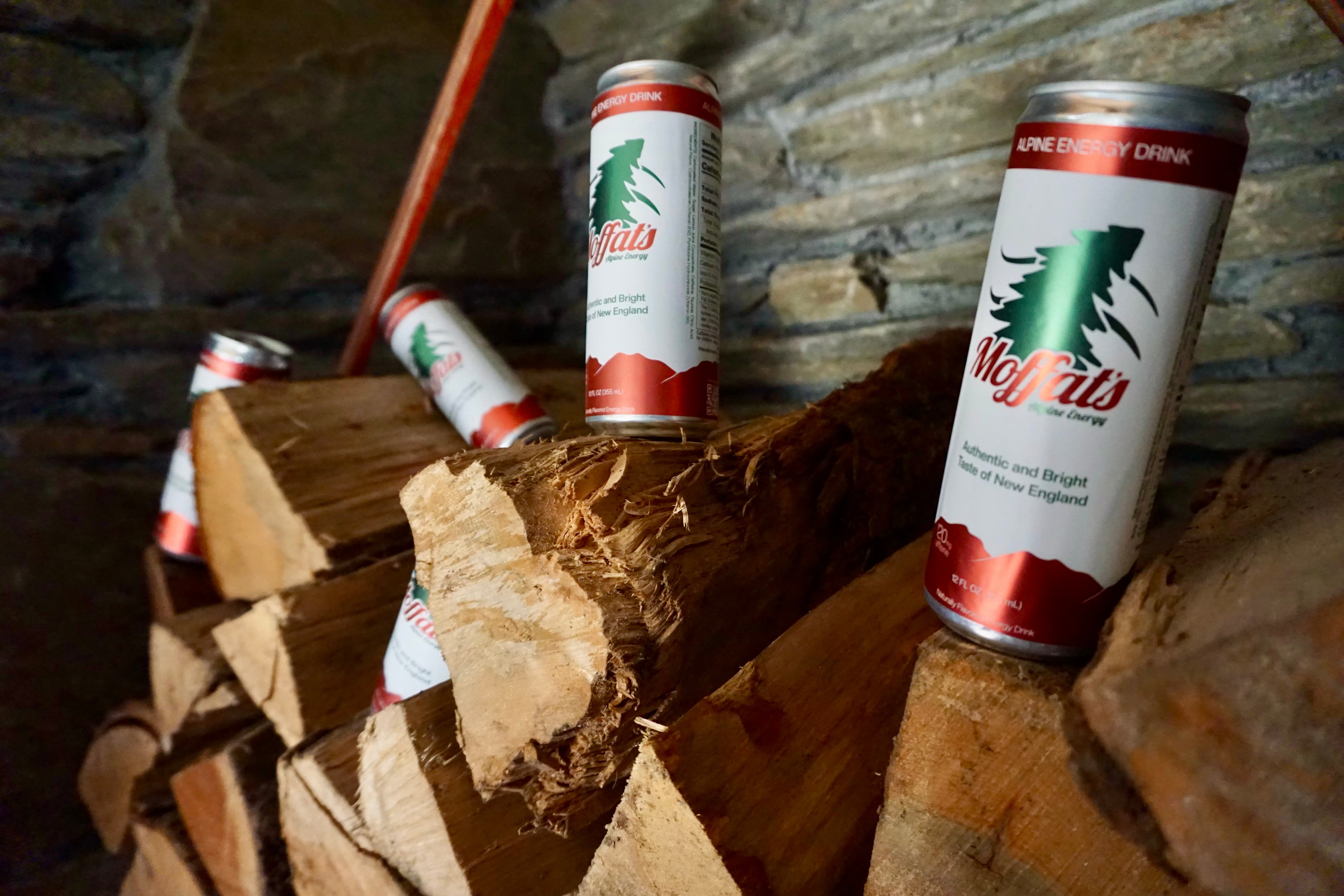 Cans of Moffat's Alpine Energy Drink by the fire in a ski lodge