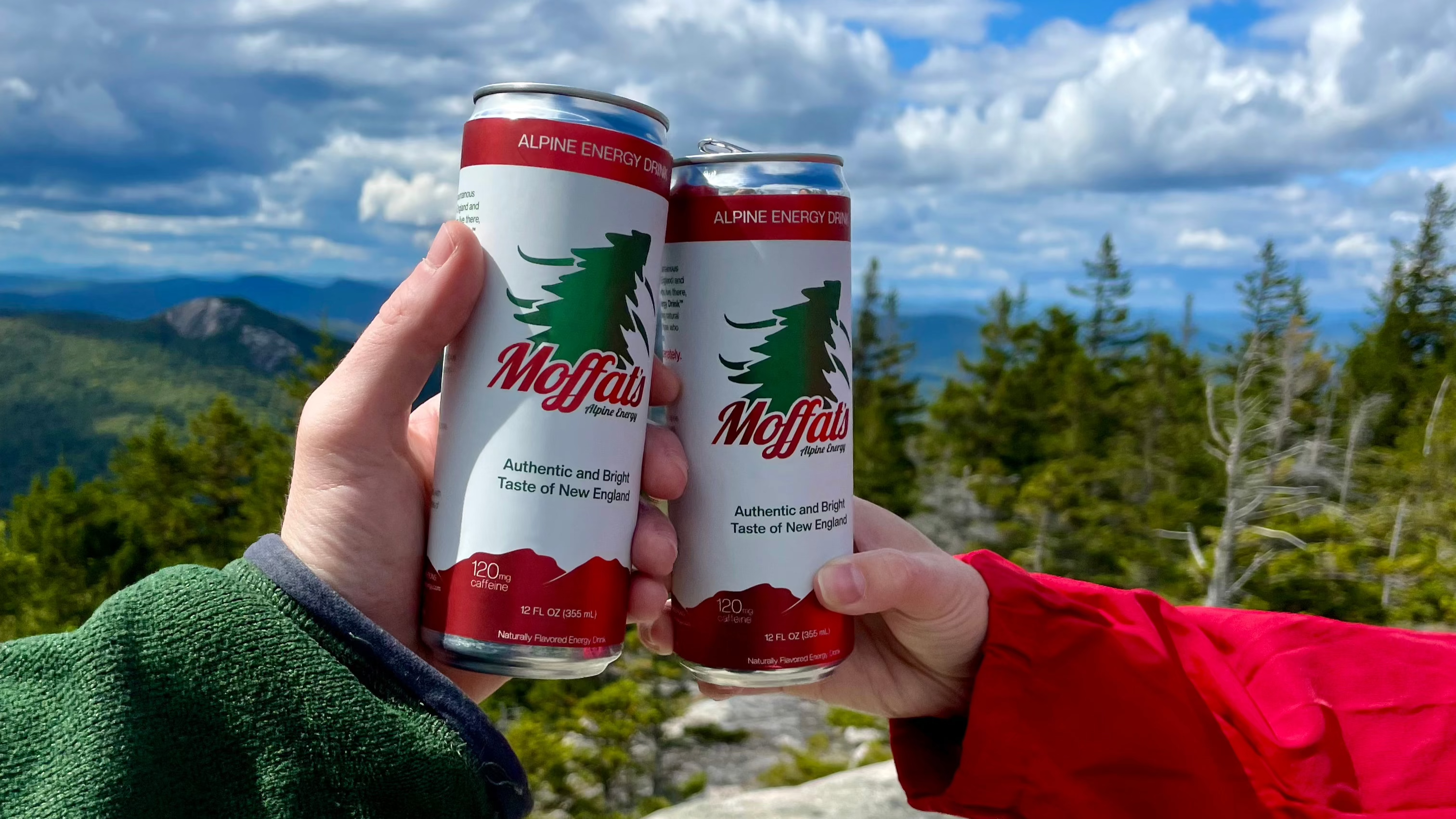 Cans of Moffat's Alpine Energy Drink on the top of a New England mountain